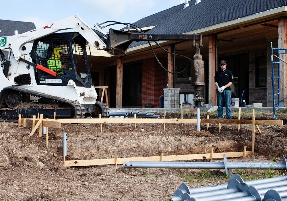 construction crew installing helical piers