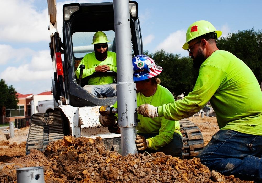 construction working installing helical piers