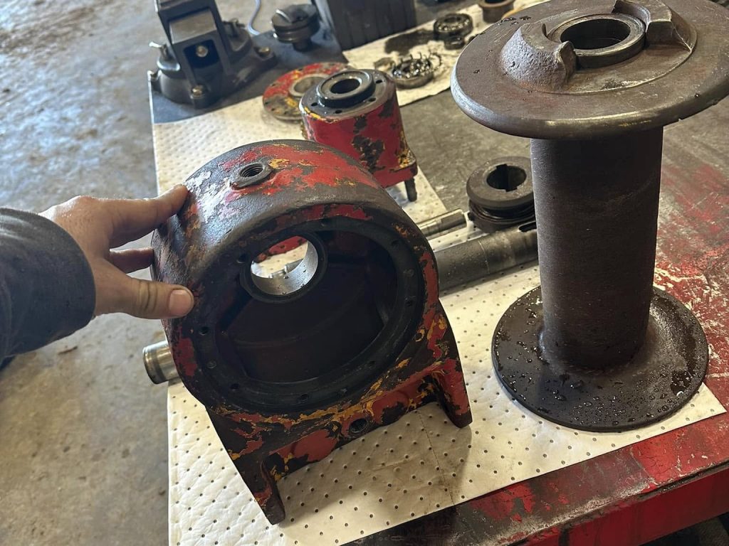 Team Member inspects disassembled machinery.