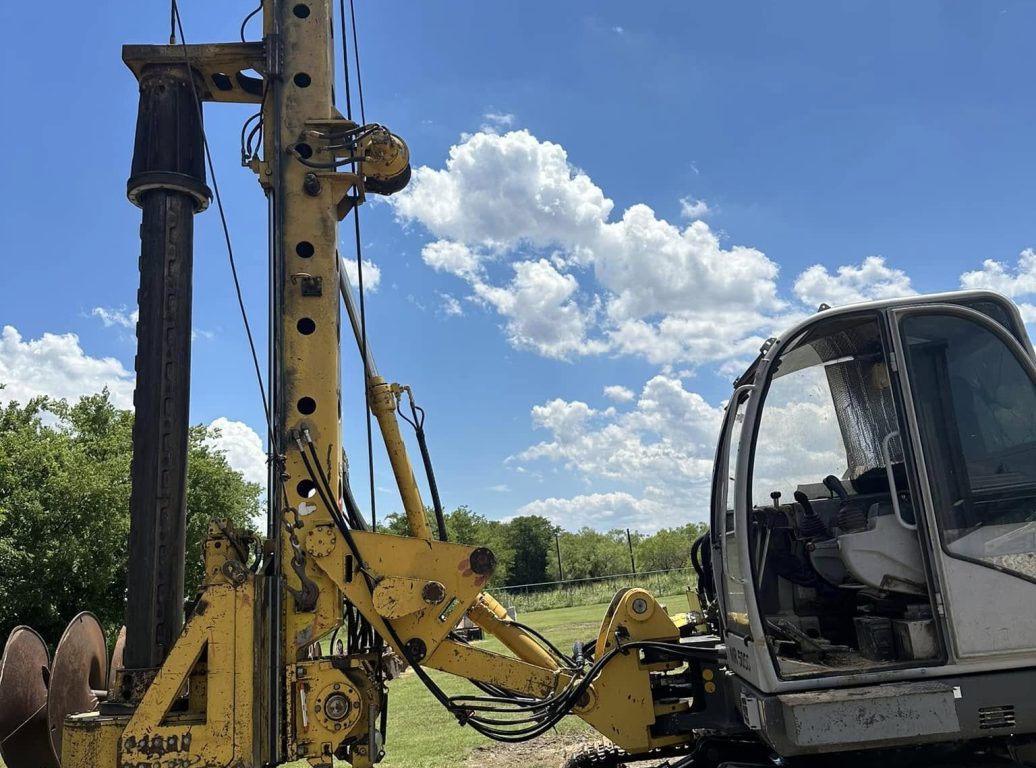Heavy-machinery-installing-a-helical-pier