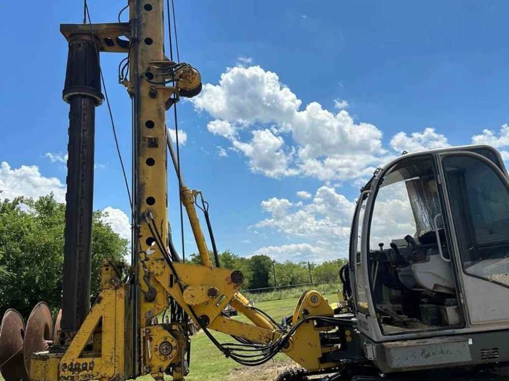 Heavy-machinery-installing-a-helical-pier