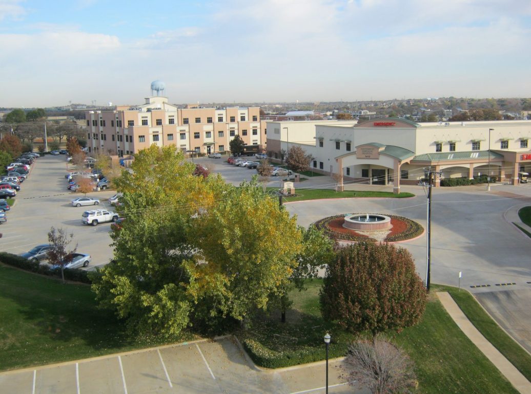 Hurst, Texas Town Center civic area with the city water tower, Southwest medical center and landscaped fountain roundabout