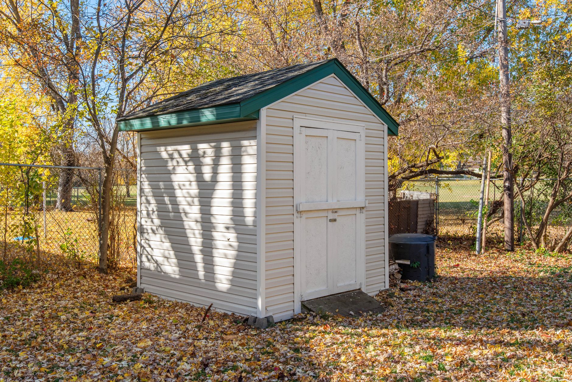 Backyard wooden storage shed sitting on a stable foundation