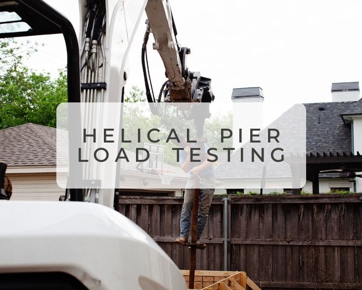 Helical pier driving equipment at a residential job site — load testing
