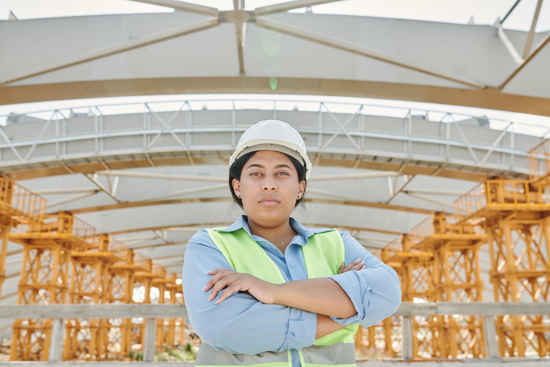 Engineer in safety gear inspecting a commercial building structure