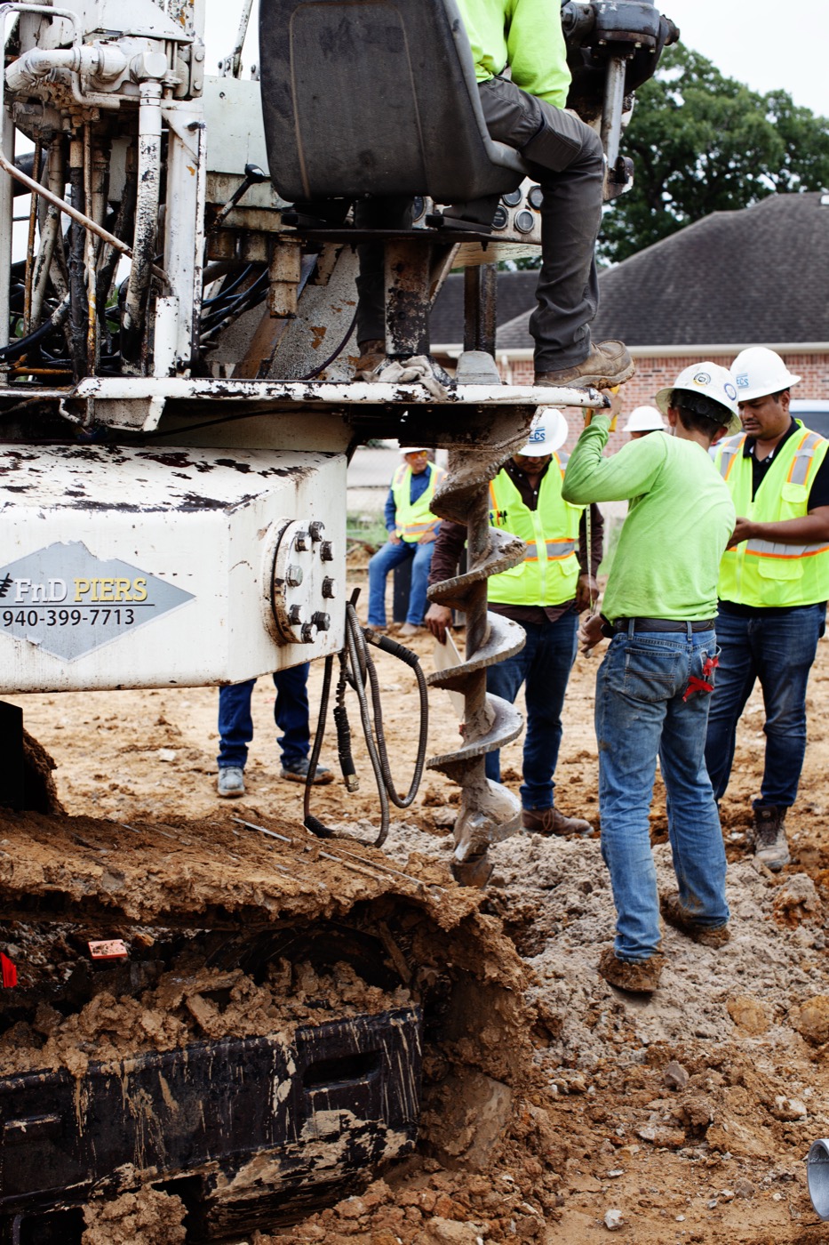 FnD Piers rig and crew installing helical piers on a jobsite
