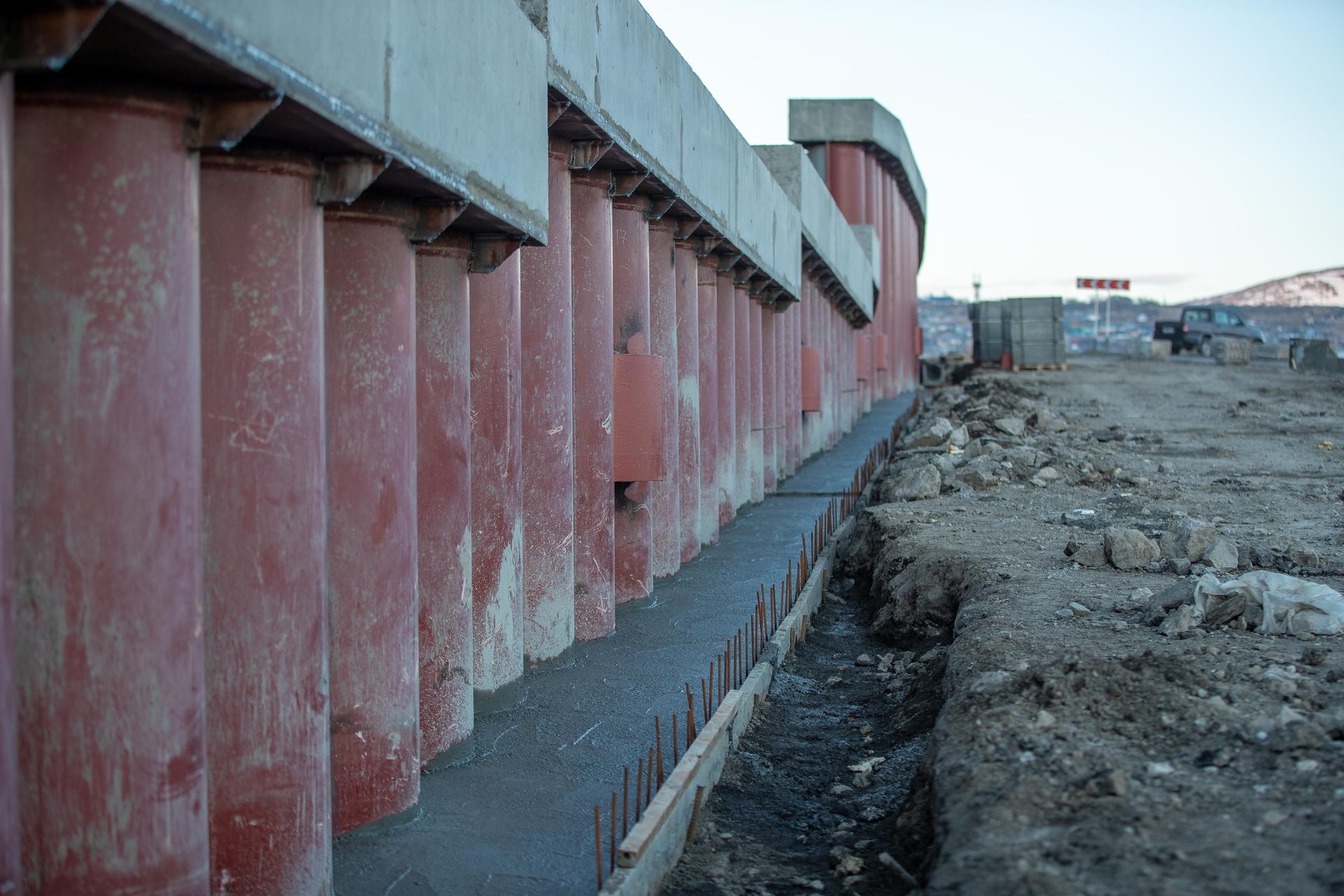 Rows of heavy concrete support columns bearing a structural load