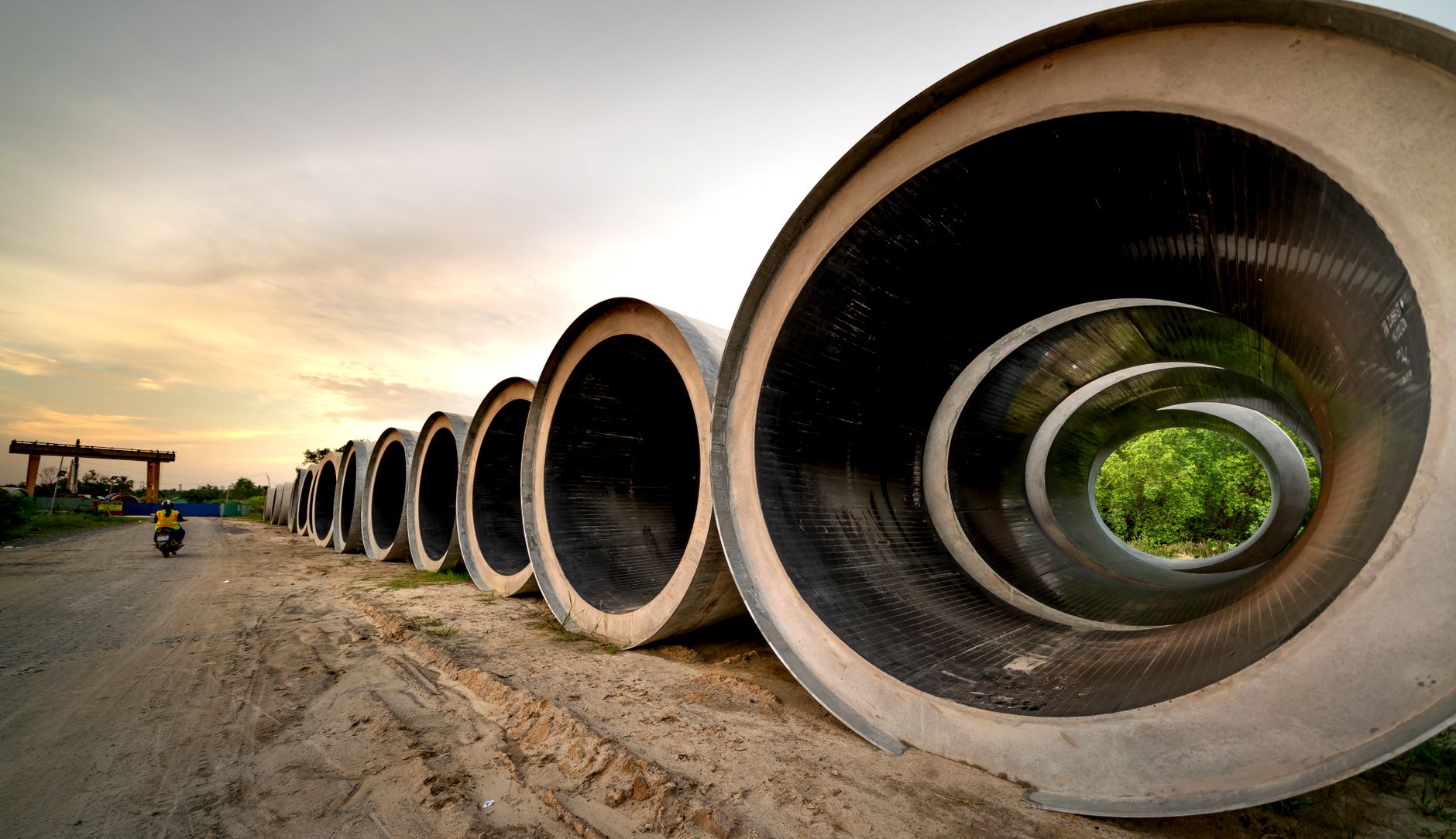 Large pipes staged at a midstream energy pipeline construction site