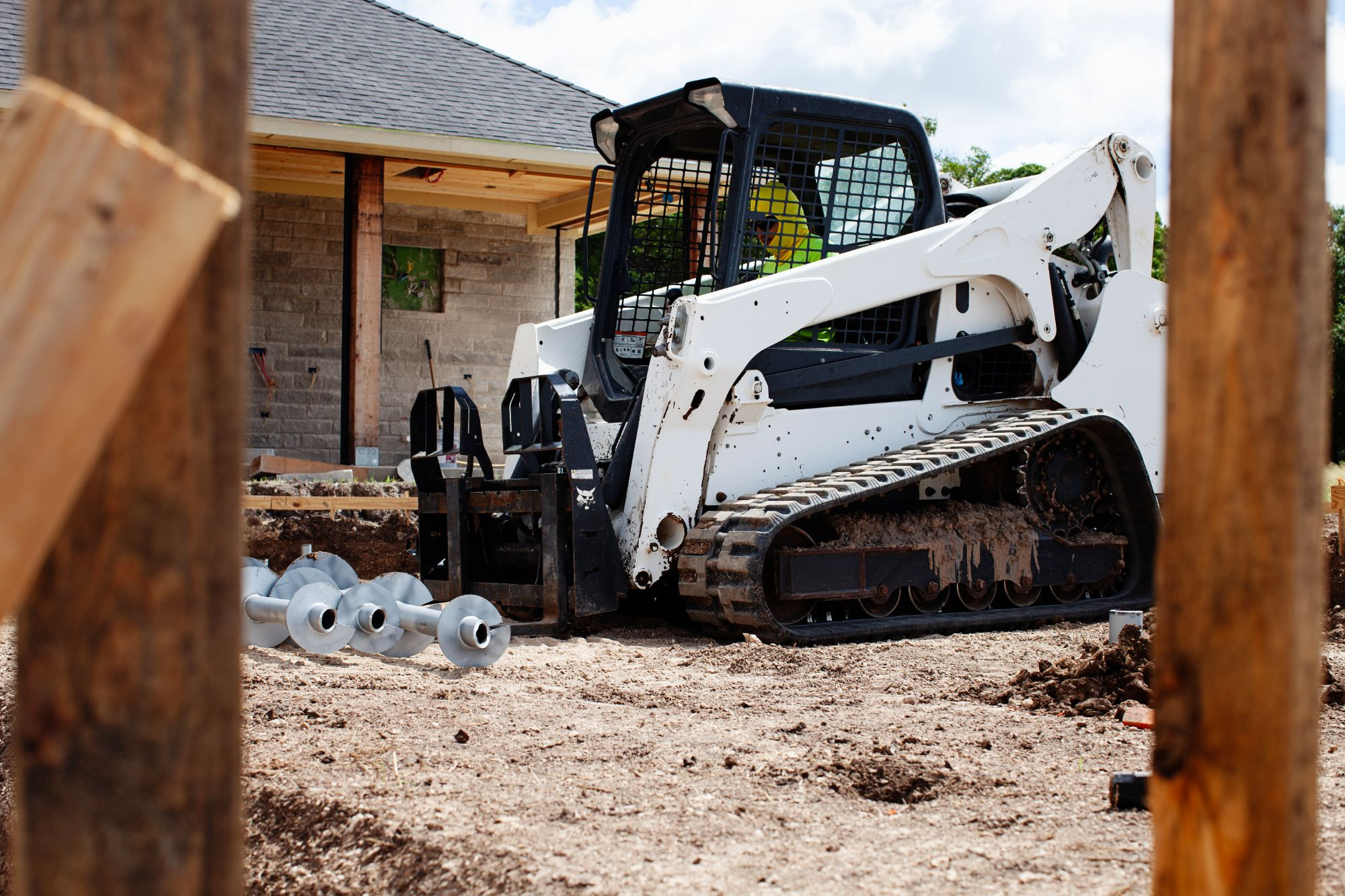 FnD Piers helical pier auger flights staged at a new construction site, serving Eagle Mountain, TX
