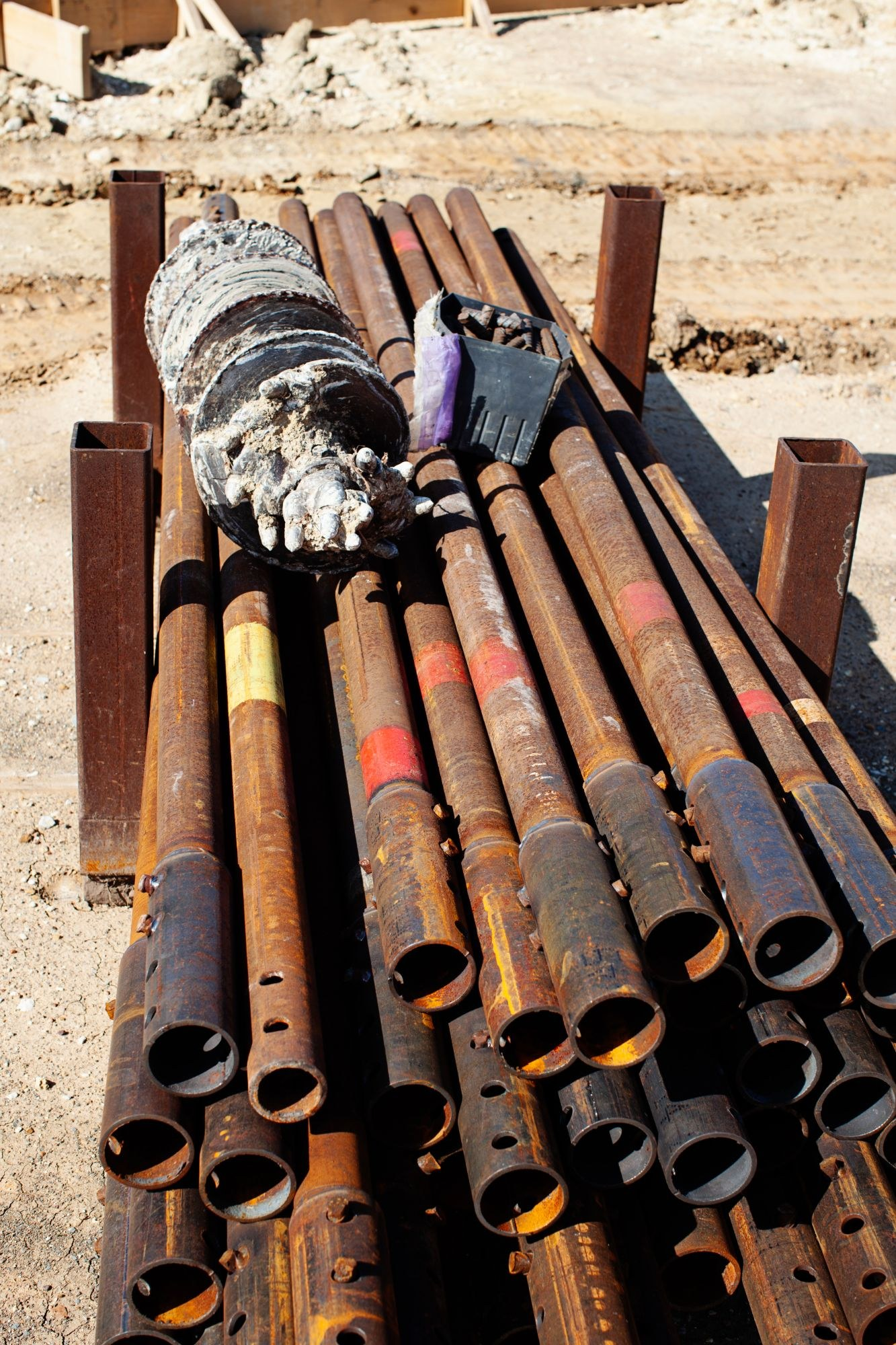 FnD Piers helical pier extension shafts and a torque head staged on site, serving Haslet, TX