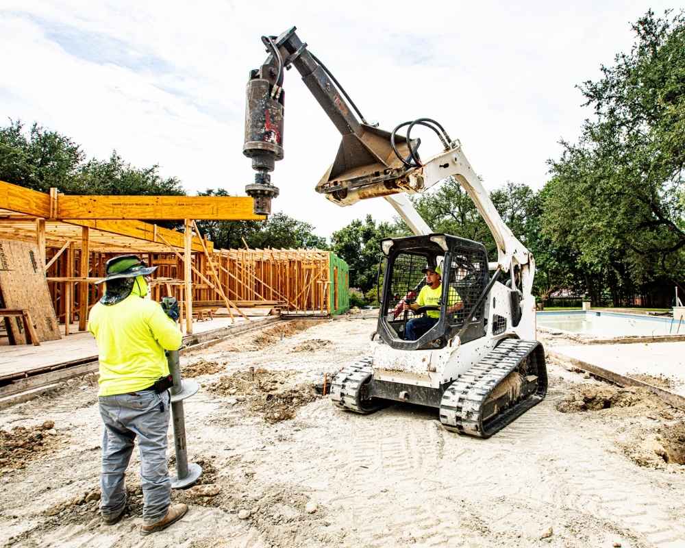 helical pier installation men at work