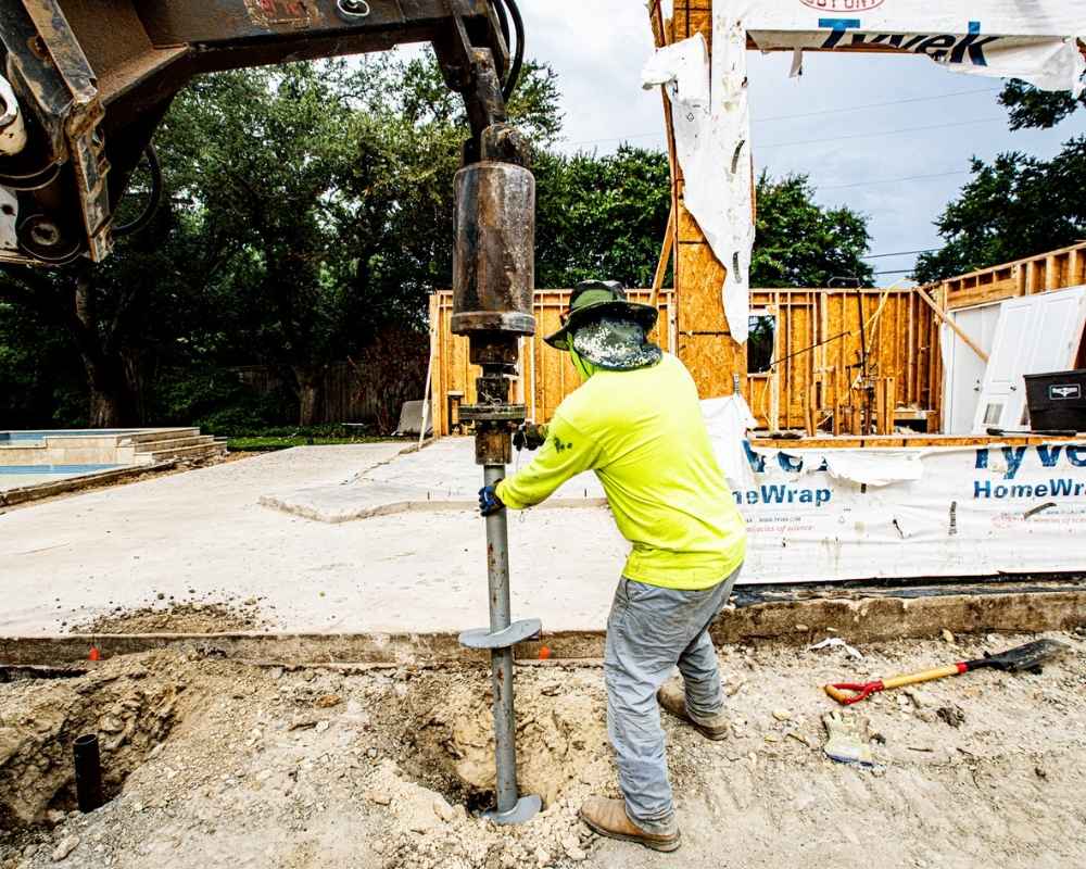 men of fnd piers installing helical piers